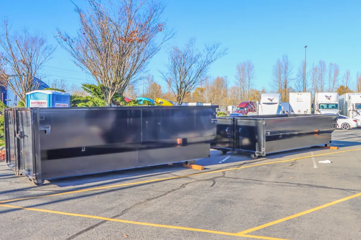 Professional dumpster rental service with roll-off container on residential driveway in Great Barrington